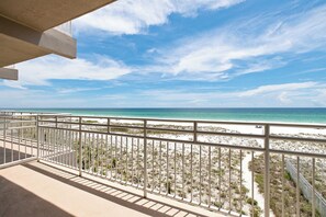 A balcony with a view of a beach and ocean. - Gulf Front Condo  at Seahorse Condos | Dog Friendly | Sleeps 9 (Pensacola Beach)