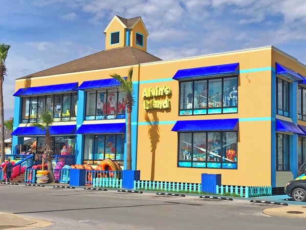 A building with a sign reading 'Alvin's Island' and a beach-themed facade. - Gulf Front Condo at Seahorse Condos | Dog Friendly | Sleeps 9 (Pensacola Beach)