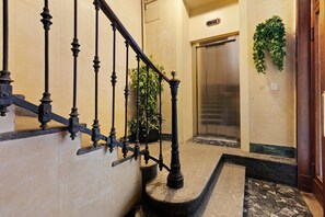 A staircase with ornate black balusters leading to an elevator. - Moscova Boutique - One Apartment with Wi-Fi and Air Conditioning (Milan)