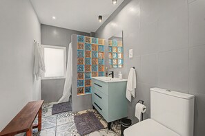 A bathroom with a window, a sink, a toilet, and a mirror. - Villa 'Finca Raziel' with Pool, Mountain Views, and Wi-Fi (Cártama)