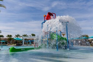 A water park with a large water slide and a pool area. - PROMO Contemporary 8 BR Villa, Pool/Spa, Resort  - by Blue Sky Villas (Kissimmee)