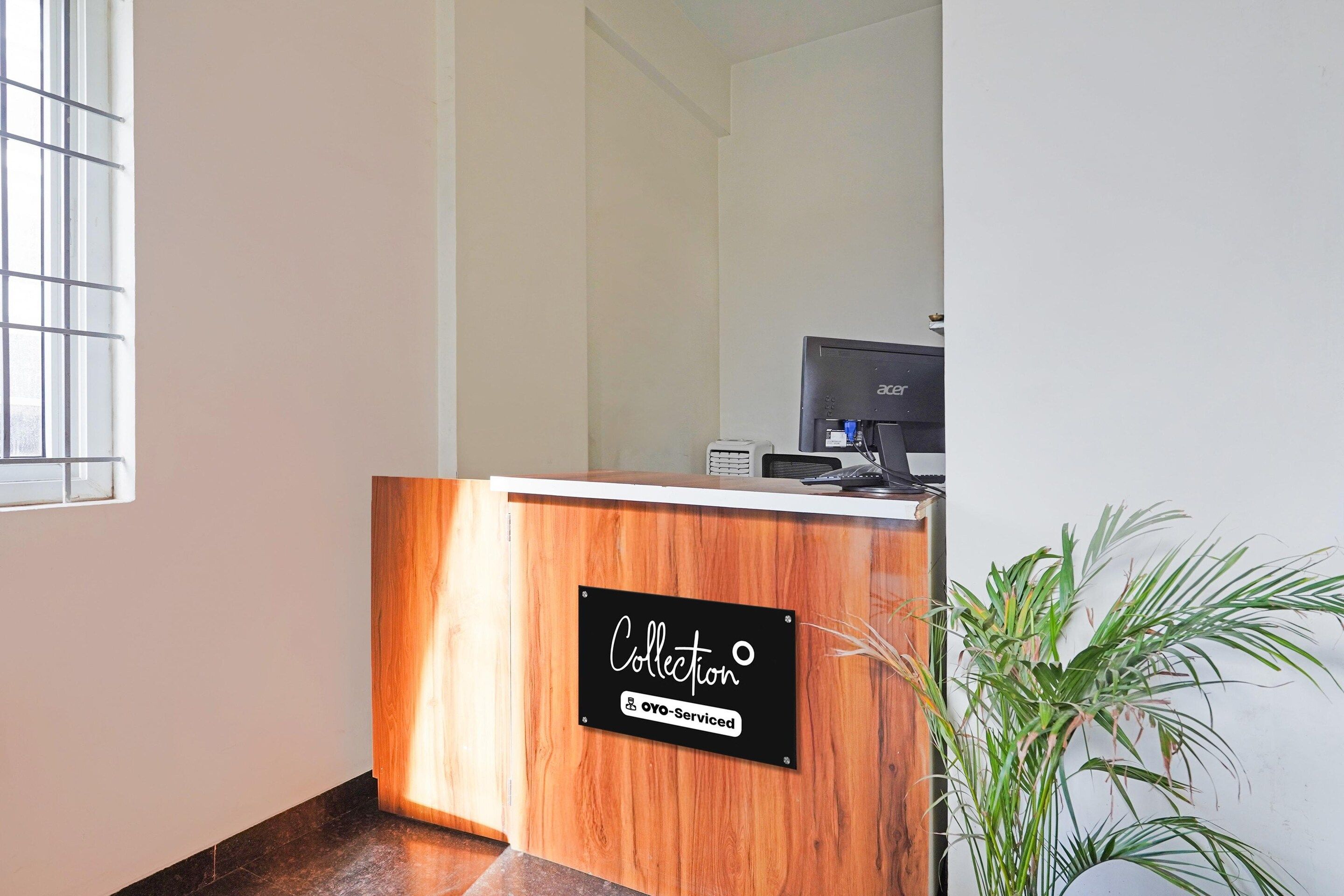 A reception desk with a sign that reads 'Collection' and 'Oyo-Serviced'.
