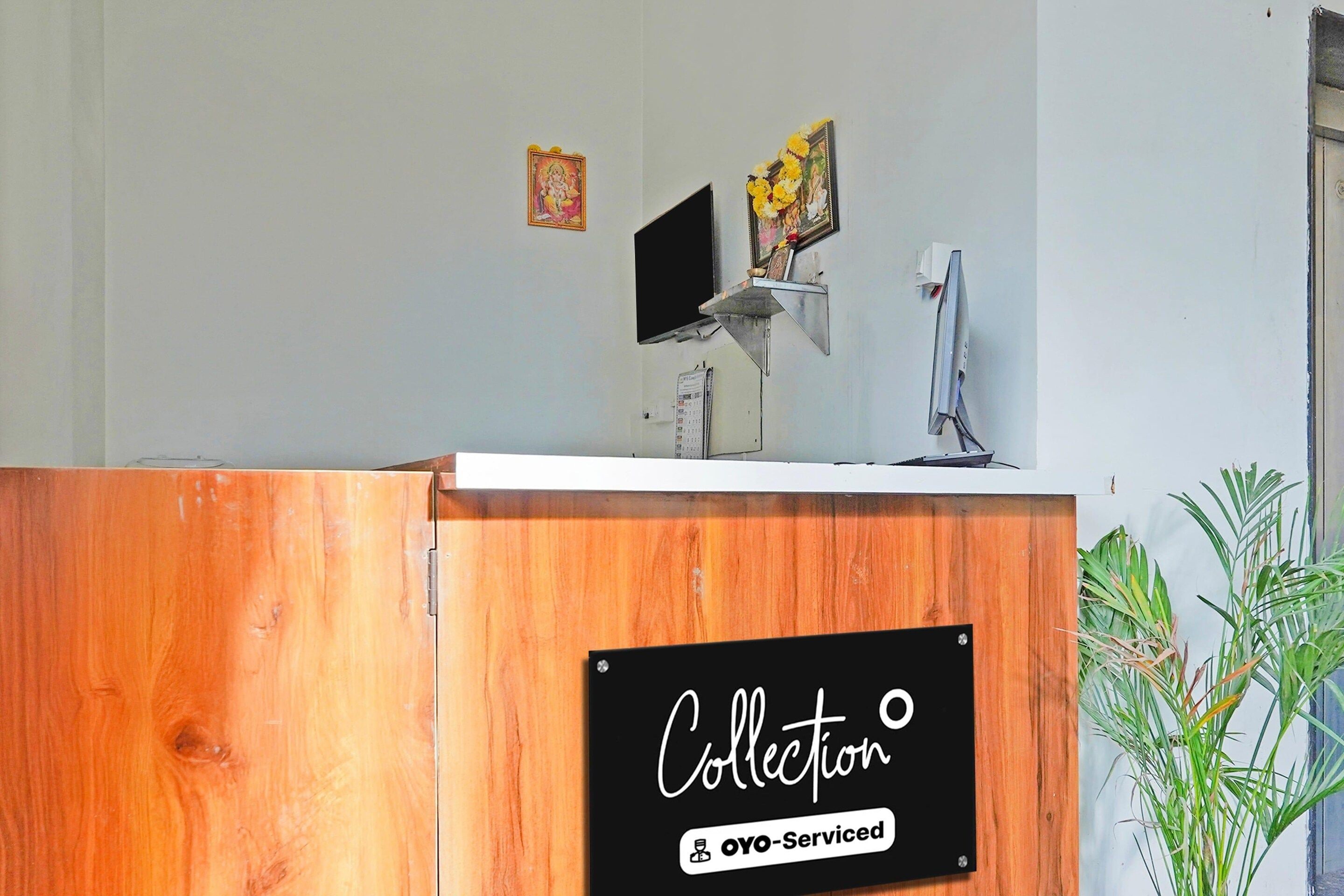 A reception desk with a sign reading 'Collection' and 'oyo-serviced'.