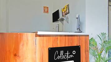 A reception desk with a sign reading 'Collection' and 'oyo-serviced'.