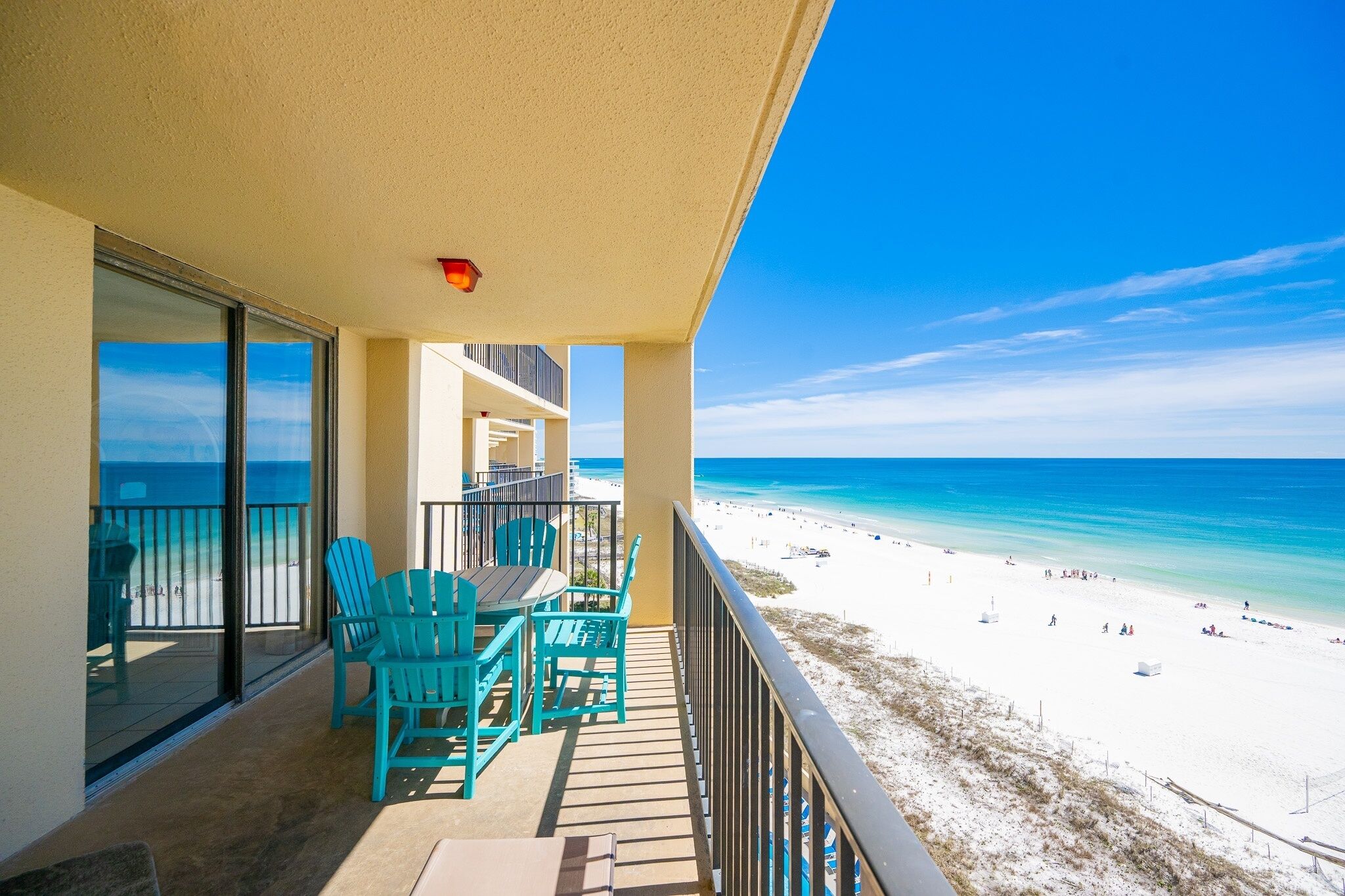 A balcony with a view of a beach and ocean.