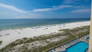 A beach with a pool area, including lounge chairs and a swimming pool. - Phoenix V 914 1 Bedroom Condo (Orange Beach)