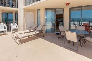 Ein Balkon mit Lounge-Möbeln, einem Tisch und Meerblick.