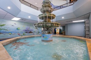 A multi-tiered fountain in a pool with a mural of fish and flowers on the walls. - Phoenix V 214 1 Bedroom Condo (Orange Beach)