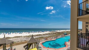 A pool area with a view of the beach and ocean. - Phoenix V 214 1 Bedroom Condo (Orange Beach)