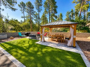 A covered outdoor seating area with a grill and patio furniture. - Modern Prescott Hideaway-Within 1 Mile of Downtown - Fully Fenced / Private Yard (Prescott)