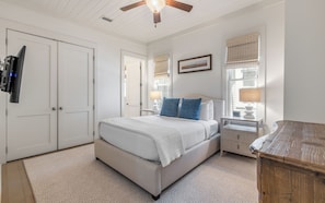 A bedroom with a bed, bedside tables, a ceiling fan, and a window with blinds. - 287 W Lake Forest Dr - WaterColor Home (Santa Rosa Beach)