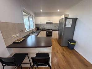 Microwave, toaster, cookware/dishes/utensils, dining tables