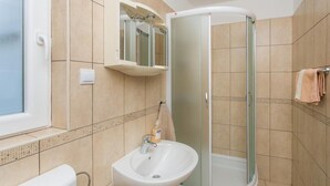 A bathroom with a shower, sink, and a mirror cabinet. - Apartments Stipo - Comfort Two Bedroom Apartment With Balcony and Sea View (Janjina)