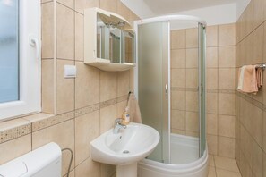 A bathroom with a shower, sink, and a mirror cabinet. - Apartments Stipo - Comfort Two Bedroom Apartment With Balcony and Sea View (Janjina)