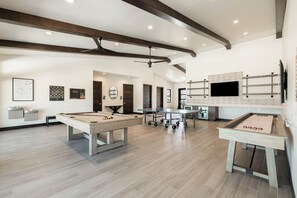 A spacious room with a pool table, a foosball table, and a television mounted on the wall. - Relax. Recharge. Repeat in DVE, Hot Tub, Pet Friendly (Heber City)