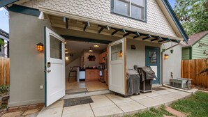 A residential property with a covered patio, a kitchen area, and a front door. - New! Private Carriage House | Walk to Broadway Shops & Restaurants (Denver)