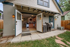 A residential property with a covered patio, a kitchen area, and a front door. - New! Private Carriage House | Walk to Broadway Shops & Restaurants (Denver)