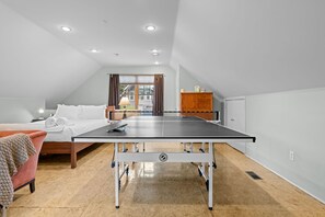 A room with a ping pong table, a bed, a desk, and a window with curtains. - New! Private Carriage House | Walk to Broadway Shops & Restaurants (Denver)