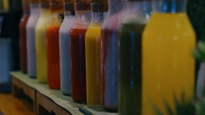 A row of glass bottles with cork stoppers, likely containing beverages. - SElaf Almaqam Nour (Makkah)