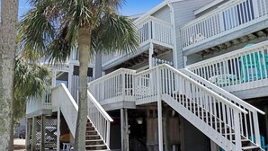 A multi-level building with a staircase leading to a balcony. - 🌊Coastal Townhouse | Pool & Tennis Court | Walk2Beach | Barrier Dunes 542 - 55 (Cape San Blas)