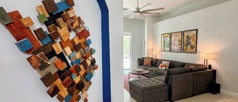 A living room with a sectional sofa, a coffee table, and a ceiling fan.