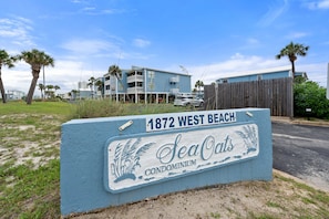 A sign for 1872 West Beach, indicating a condominium development with a view of the beach and ocean. - Sea Oats Condo With Beach and Bay Access (Gulf Shores)