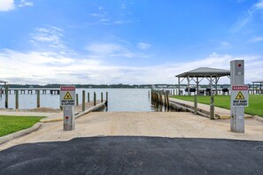 A boat ramp with a warning sign indicating it is slippery. - Sea Oats Condo With Beach and Bay Access (Gulf Shores)