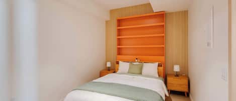 A modern bedroom with a bed, bedside tables, and a built-in shelving unit.