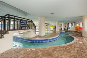 An indoor swimming pool with a no diving or jumping sign, a children's play area, and a brick floor. - Ocean front at Ocean reef resort, waterpark, beach (Myrtle Beach)