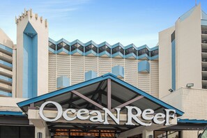 The Ocean Reef building with a distinctive zigzag roofline and a sign above the entrance. - Ocean front at Ocean reef resort, waterpark, beach (Myrtle Beach)