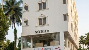A multi-story building with the name 'SOBHA' and 'Pavement' on the facade. - Hotel Poptavern Townbridge (Thiruvananthapuram)