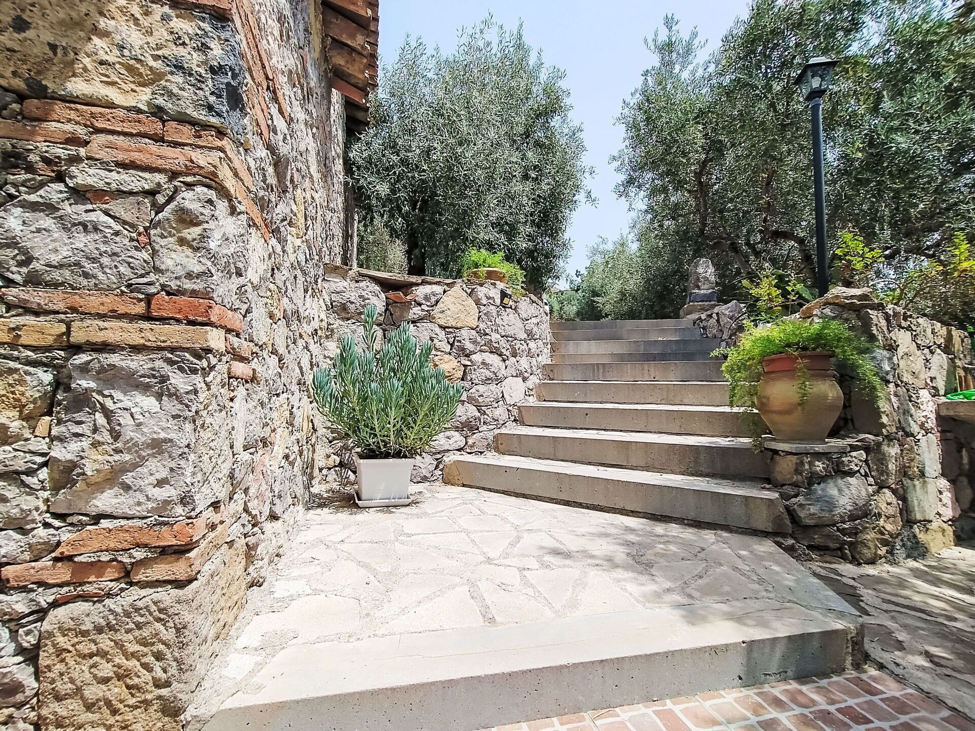 A stone staircase leading up to a building with a brick facade.