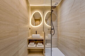A modern bathroom with a glass-enclosed shower, a vanity with a sink, and a mirror with an oval frame. - Gorgeous Air-conditioned 2-BR/2Ba  - Saint-Germain (Paris)
