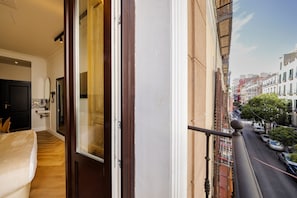 A balcony with a view of a street and buildings.