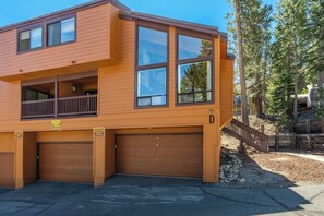 A two-story building with a garage, a balcony, and a wooden fence. - Beautiful updated Courchevel by the Slopes. Sleeps up to 8 guests! (Mammoth Lakes)