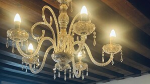 A chandelier with multiple arms and lights, a wooden ceiling, and a window with a view of buildings. - Room 'Ca Pisani Su Canal Grande Azzuro' with Wi-Fi (Venice)