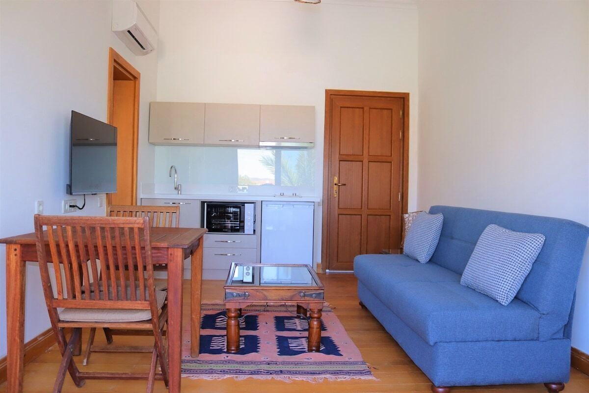 Family Suite, Patio, Sea View | Living area | 32-inch LCD TV with satellite channels