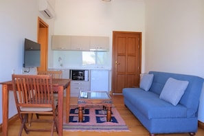 Family Suite, Patio, Sea View | Living area | 32-inch LCD TV with satellite channels