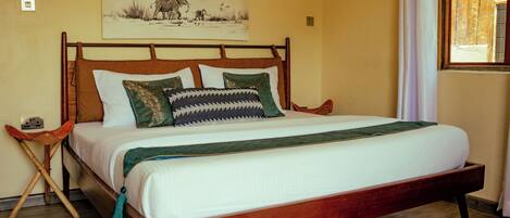 A bed with a wooden frame, white bedding, and decorative pillows.