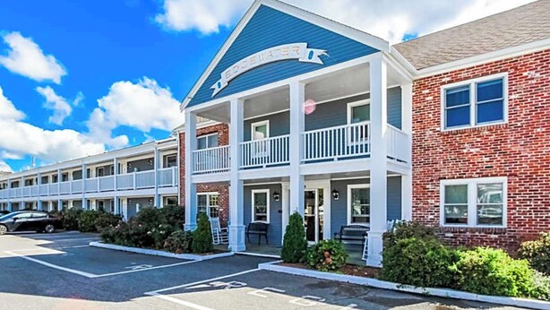 A multi-story hotel with a blue roof and white balconies. - Edgewater Beach Resort (Dennis Port)