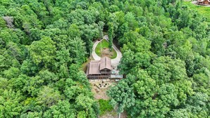 A cabin surrounded by dense forest, with a driveway leading to the entrance. - Valley Retreat Sleeps 10 Hot Tub Fire Pit (Blue Ridge)