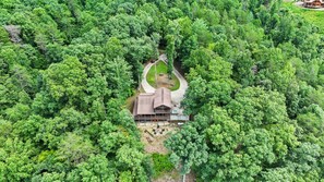 A cabin surrounded by dense forest, with a driveway leading to the entrance. - Valley Retreat Sleeps 10 Hot Tub Fire Pit (Blue Ridge)