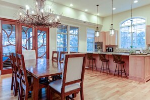 A spacious kitchen with a large island, wooden cabinetry, and pendant lighting. - Lake Lure Game Room Fire Pit Resort Access (Lake Lure)
