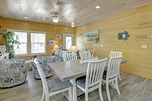 A dining area with a wooden ceiling, a ceiling fan, and a table with white chairs. - Toucan Tango- Golf Cart Friendly 3BD Home (Port Aransas)