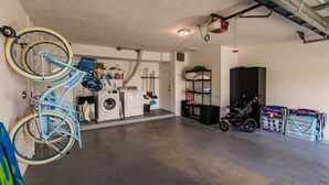 Ett garage med tvättmaskin, torktumlare och ett cykelställ.
