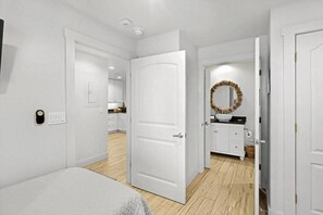 A hotel room with a bed, a bathroom with a mirror, and a kitchen area. - Incredible Ocean Views Direct Beach Access Pool (Port Aransas)