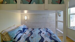 A bedroom with a bed, a window, and a view of the outside. - Sweet Home La Cabana Patio BBQ Community Pool (Port Aransas)