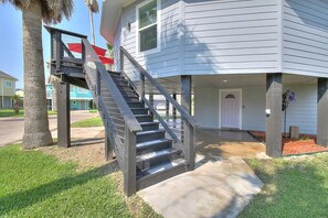A two-story building with a staircase leading to the upper floor. - La Sirena Pet Friendly Community Pool (Port Aransas)