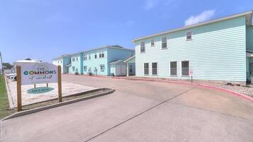 A row of light blue buildings with a sign indicating 'The Commons at Seashore.'