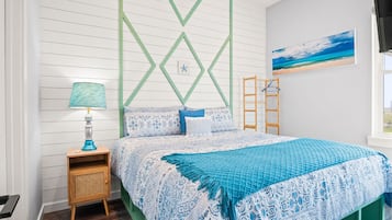 A bedroom with a bed, a nightstand, a lamp, a wall-mounted ladder, and a painting.